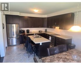 A kitchen with a table and chairs.