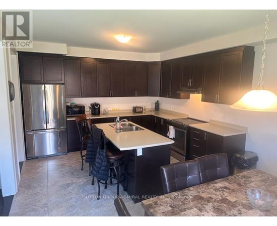 A kitchen with a table and chairs.