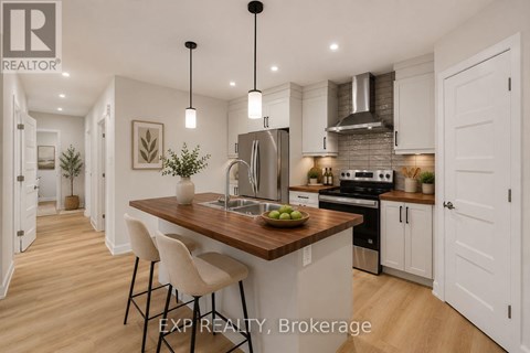 A modern kitchen with white cabinets and a wooden island.