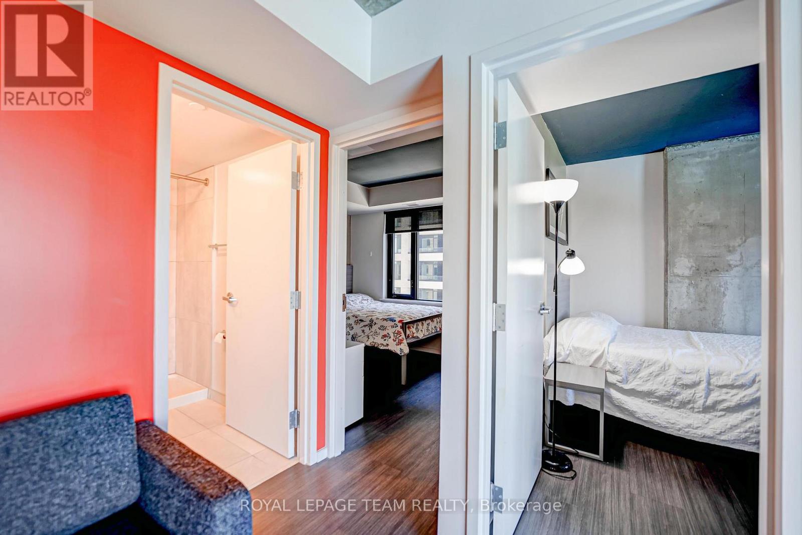 A bedroom with a bed and a couch in it.