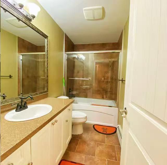 A bathroom with a sink, toilet, and shower.