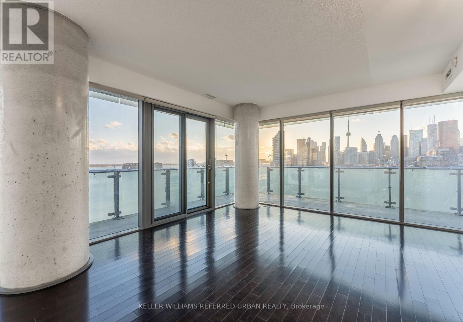 A spacious room with a view of the city skyline.