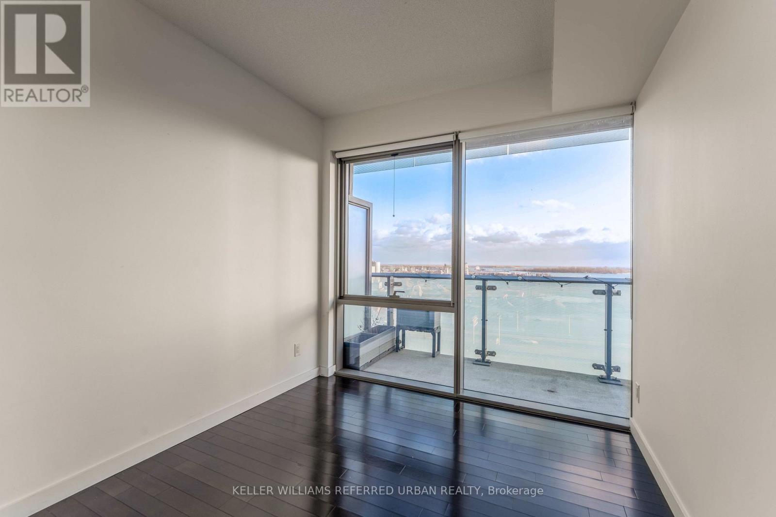 A room with a view of the city through a large window.