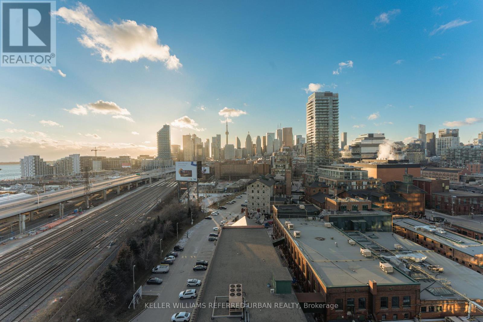 A cityscape with a highway and buildings in the background.