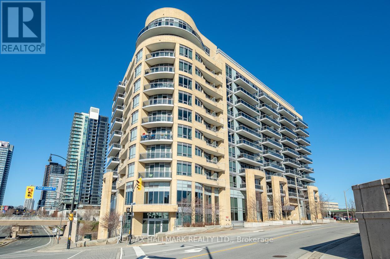A tall building with many windows and balconies is the main focus of the image.