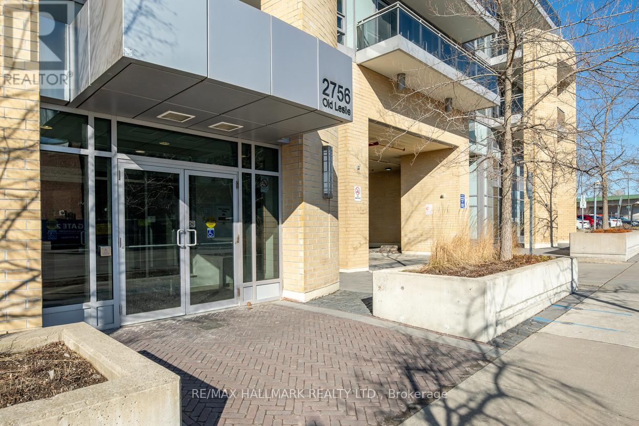 The image shows the front of a building with the sign "2755 Oak Lane" and the logo of RE/MAX Hallmark Realty LTD.