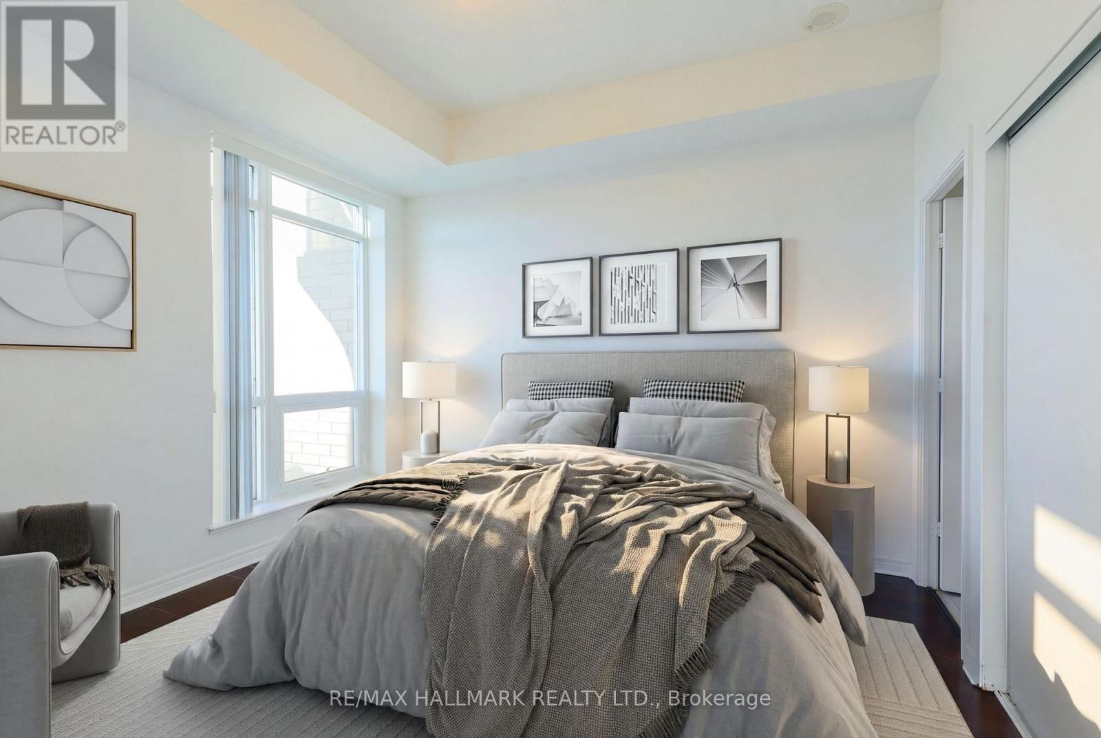 A bedroom with a large bed and a window.