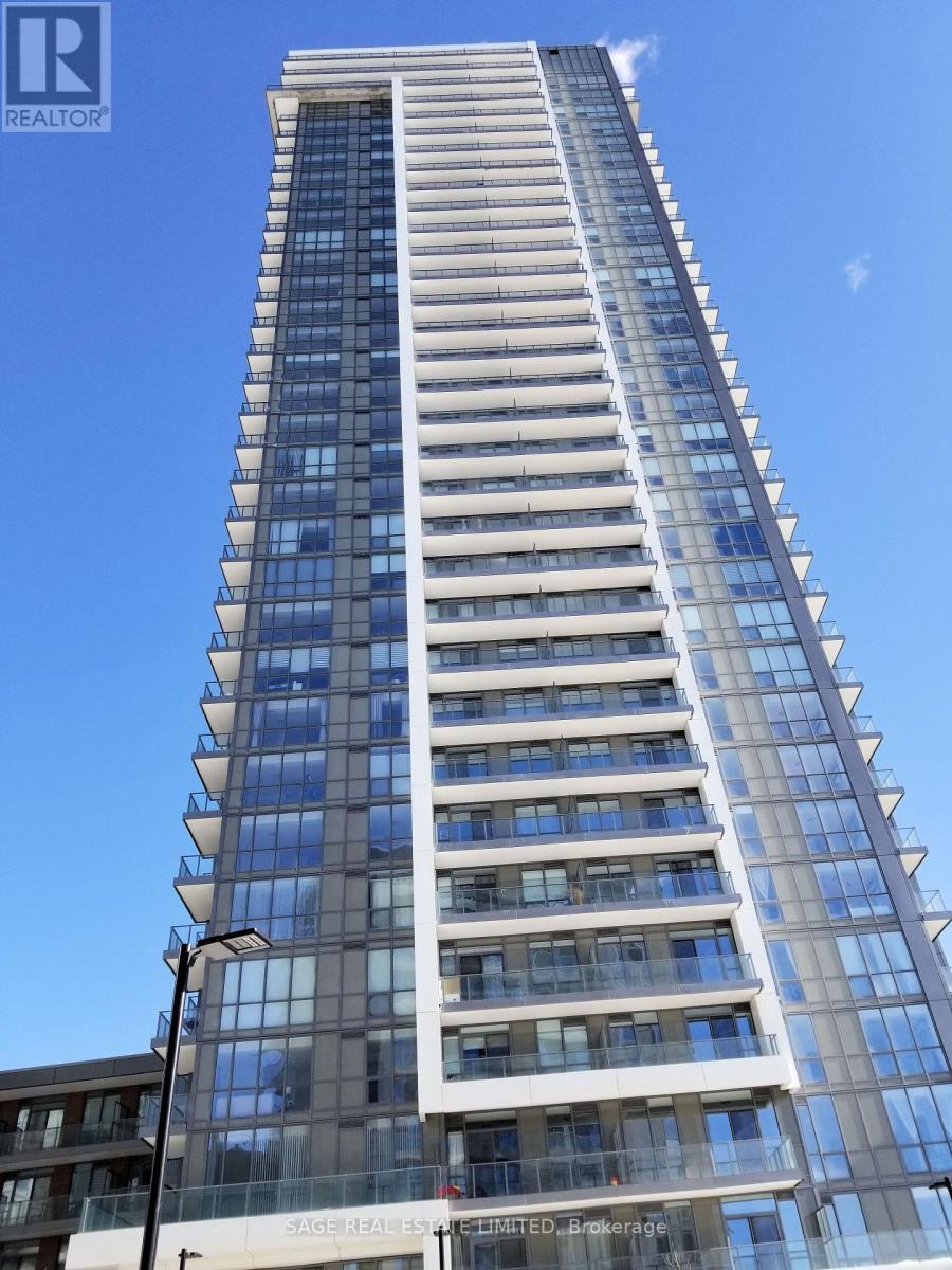 A tall building with many windows and balconies is shown.