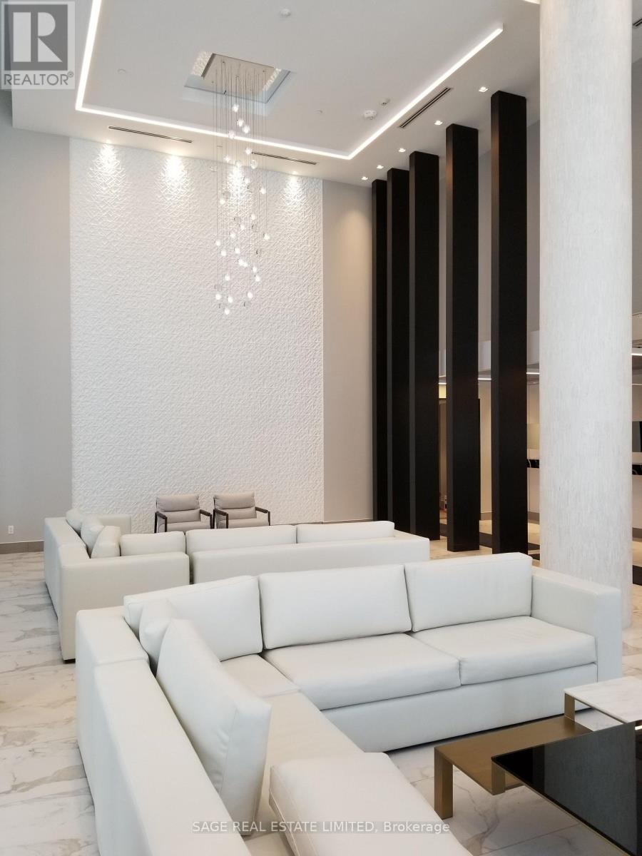 A white couch is in the middle of a room with a glass table in front of it.