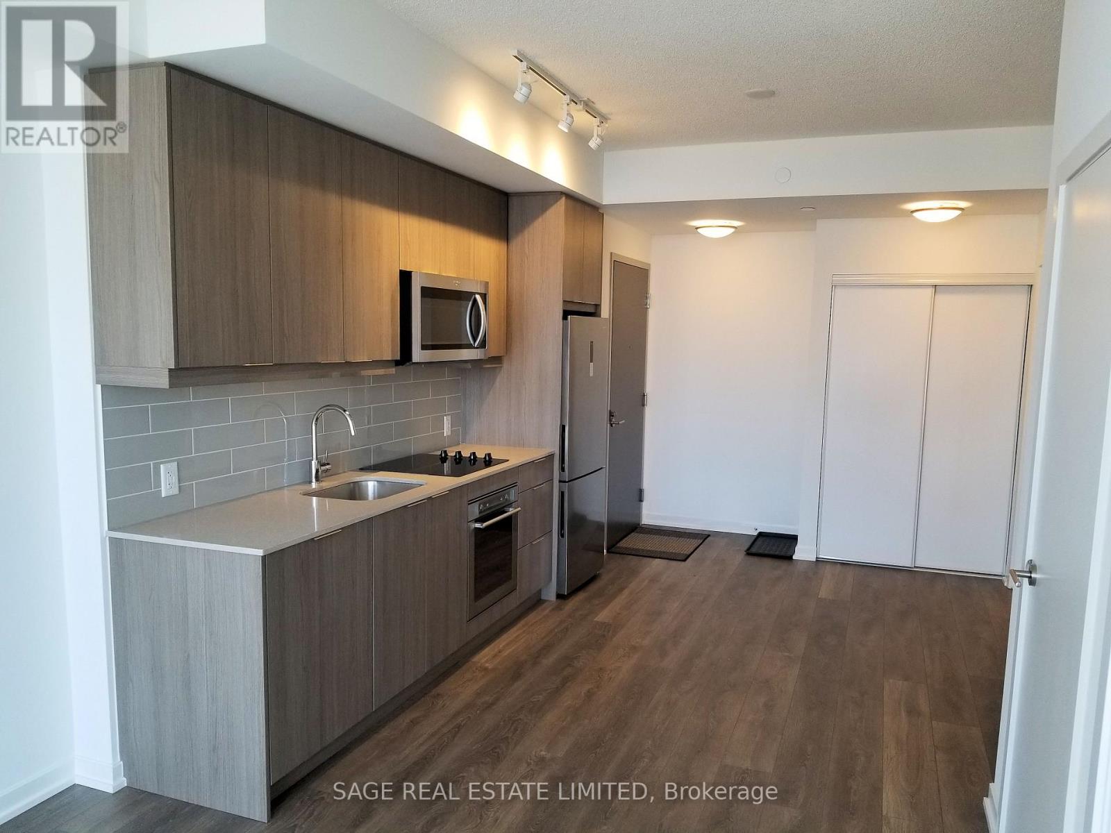 A kitchen with a microwave above the stove and a sink below it.