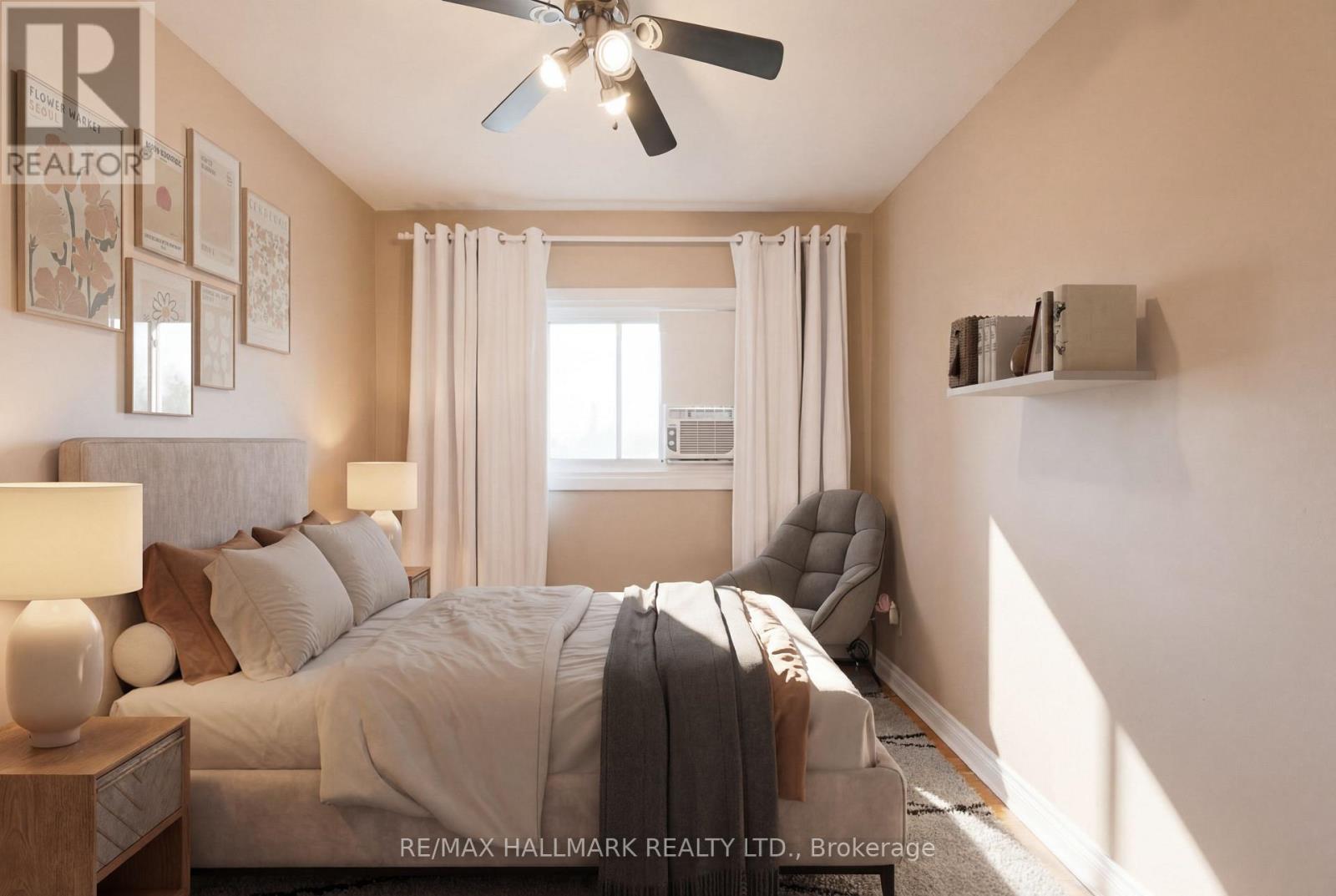 A bedroom with a large bed and a ceiling fan.
