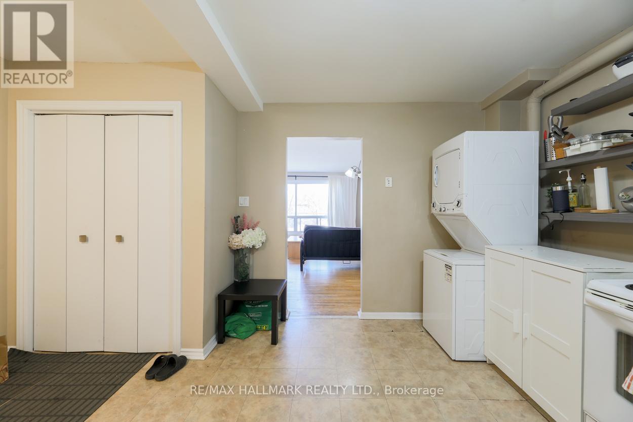 A kitchen area with a refrigerator, oven, and a dining table with chairs.