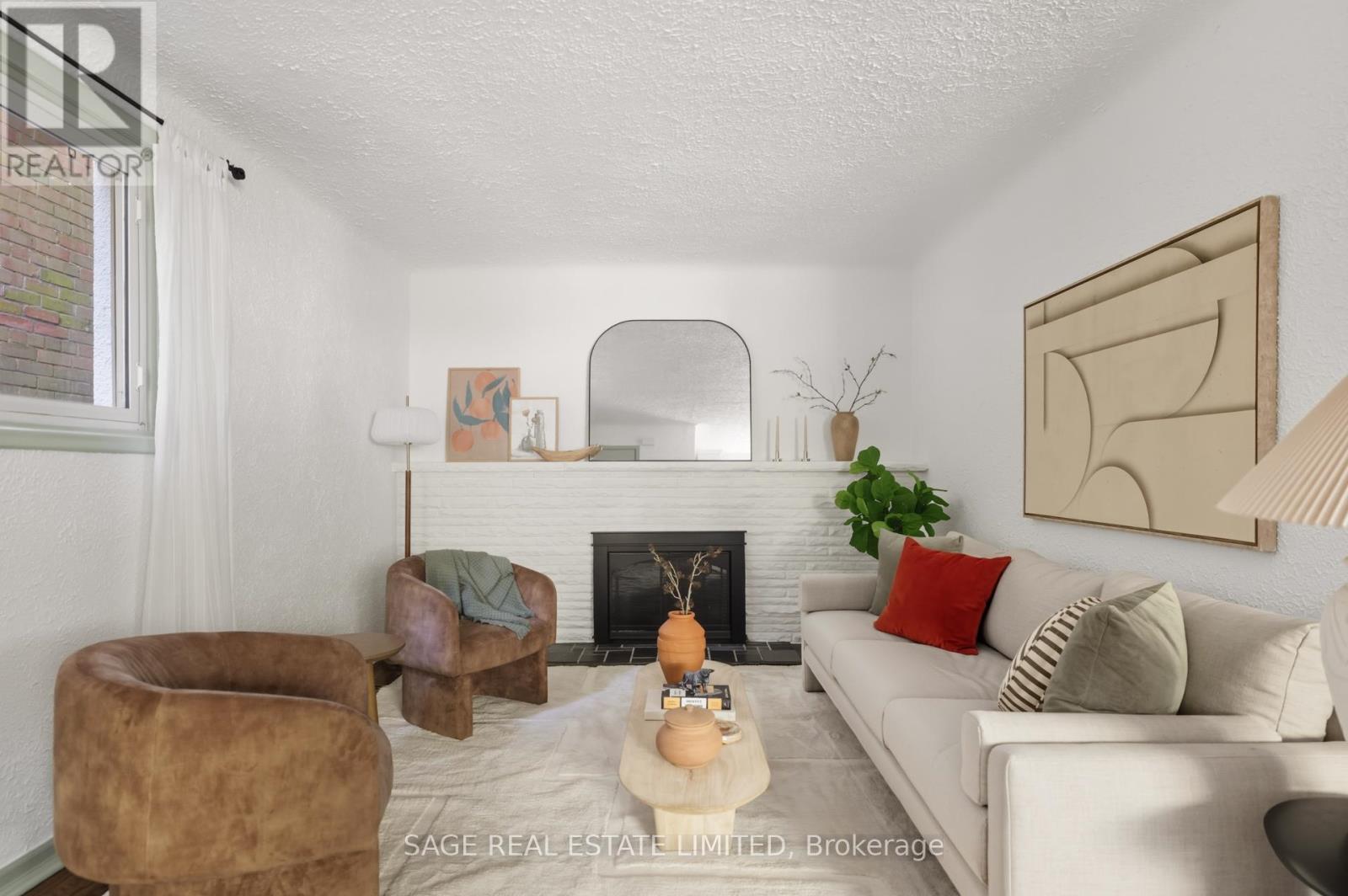 A living room with a fireplace and a brown chair.