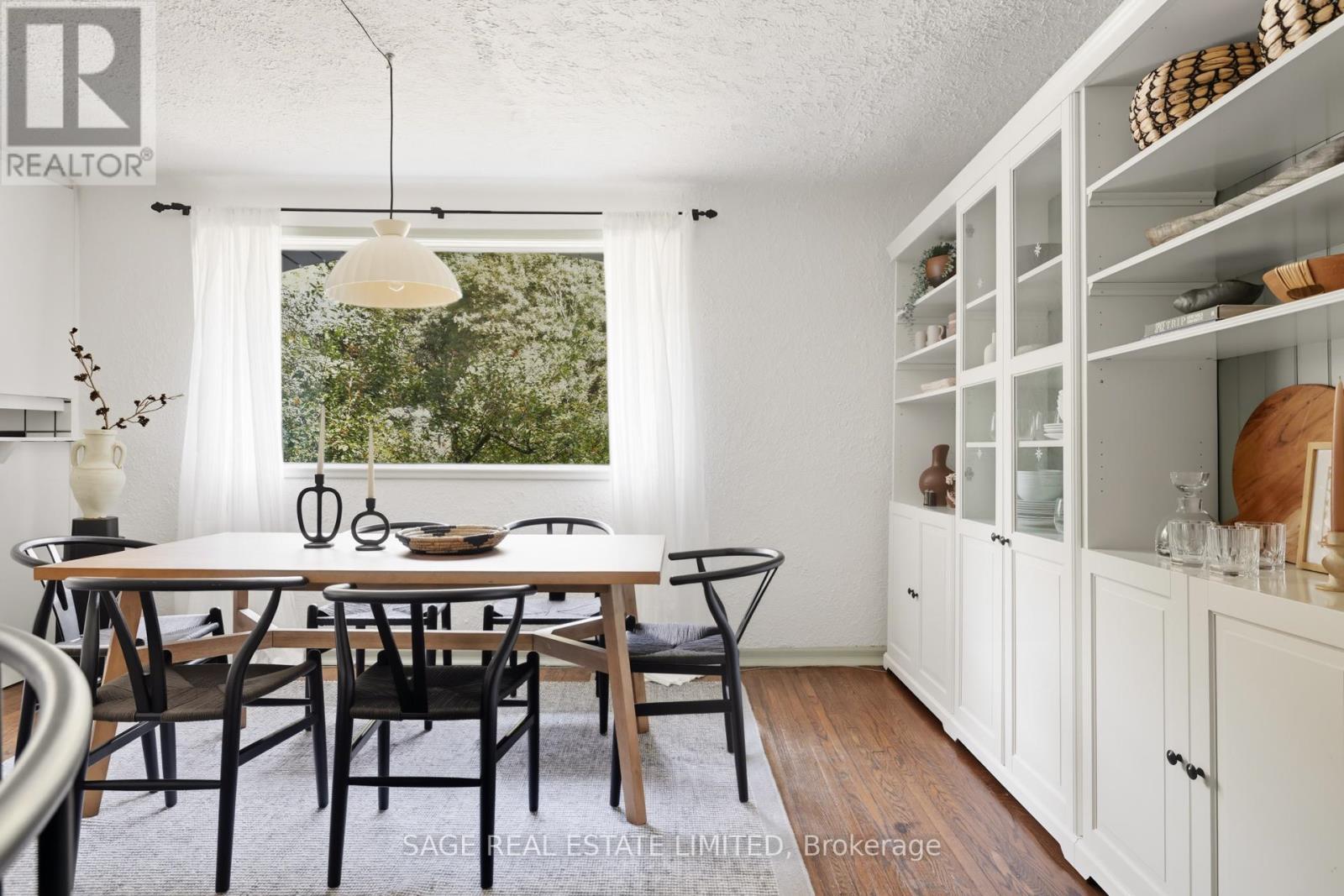 A dining room with a table set for six.