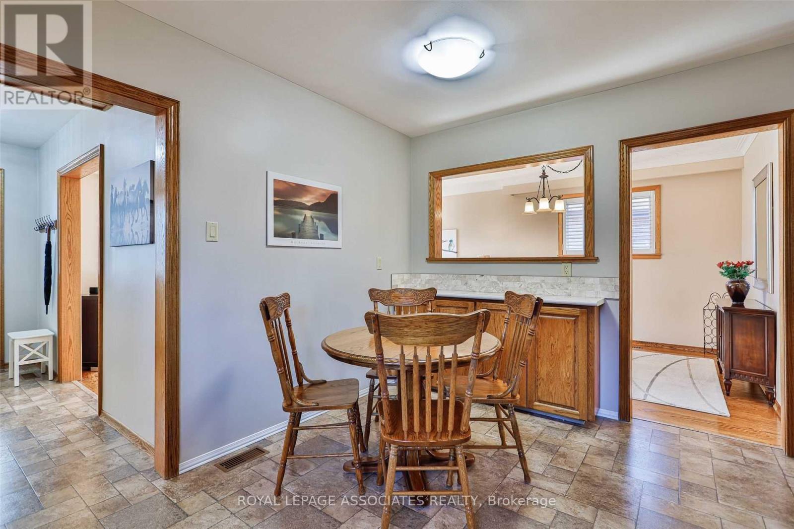 A dining room with a table and chairs.