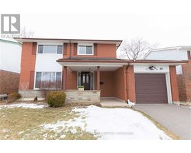 A house with a brown garage door is for sale.