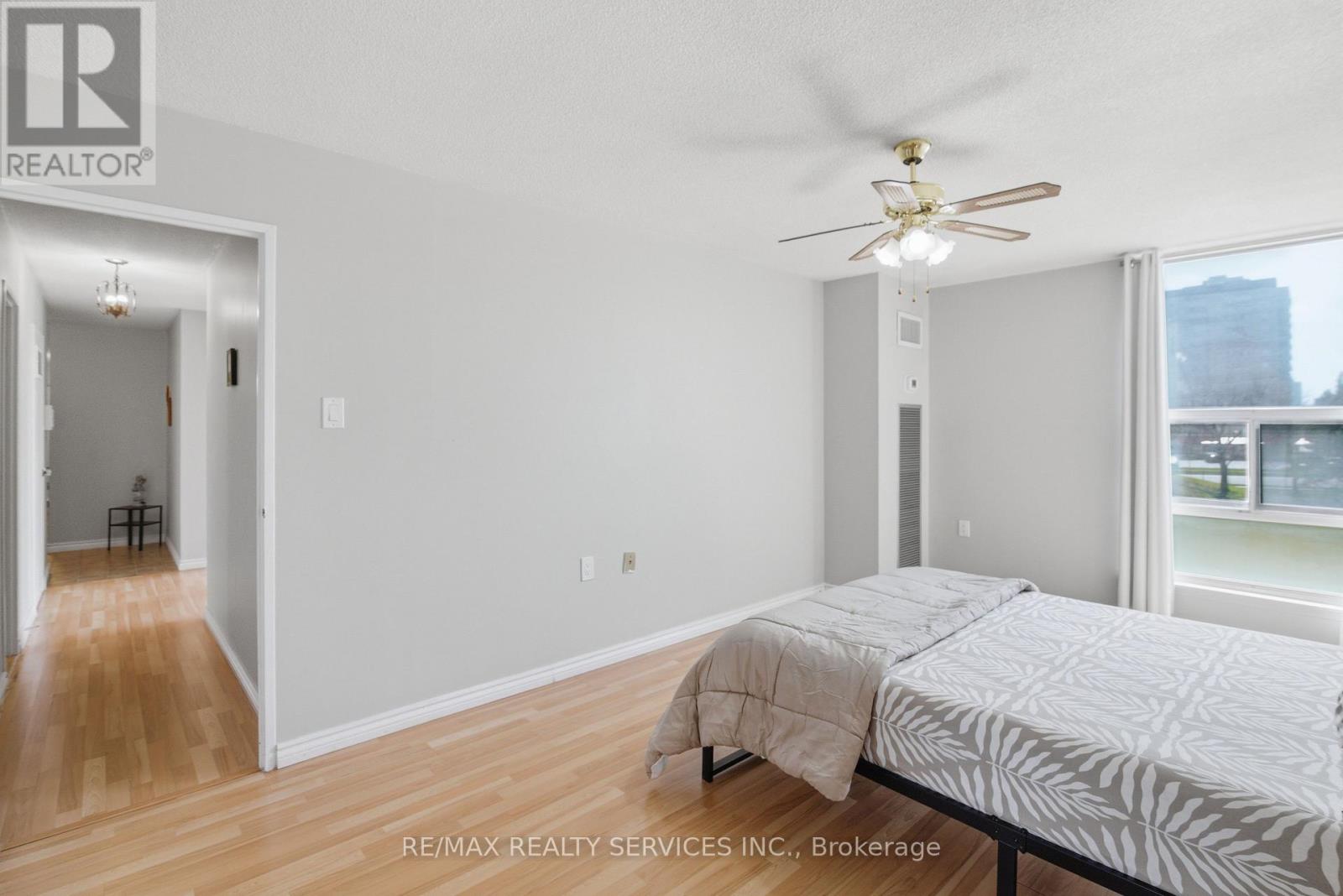A bedroom with a bed and a wooden door.