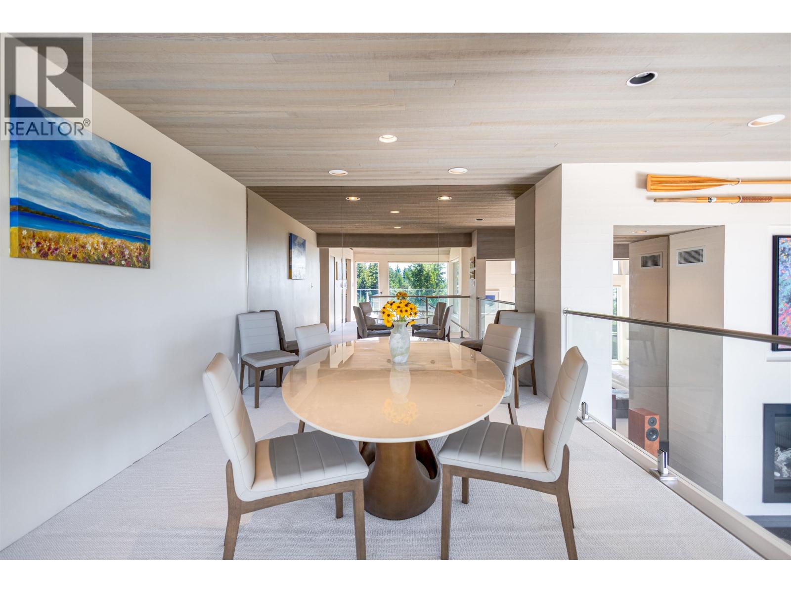 A dining room with a table and chairs.