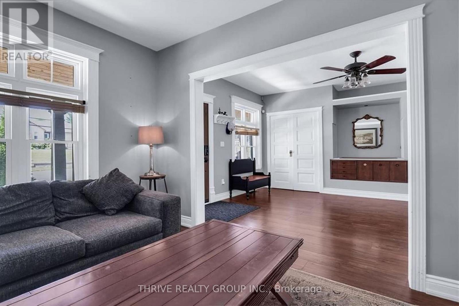 A living room with a grey couch and a wooden table.