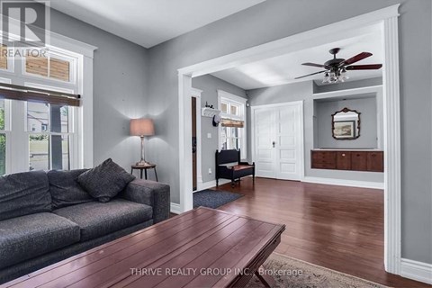 A living room with a grey couch and a wooden table.