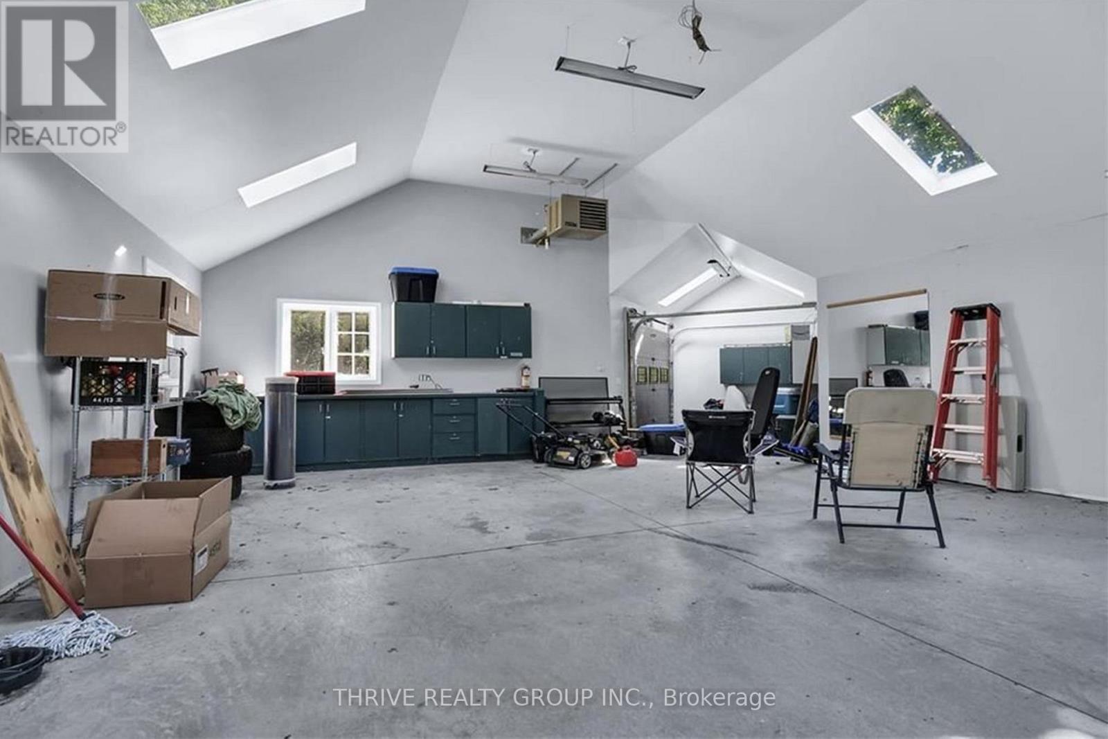 A spacious garage with a skylight and a workbench.