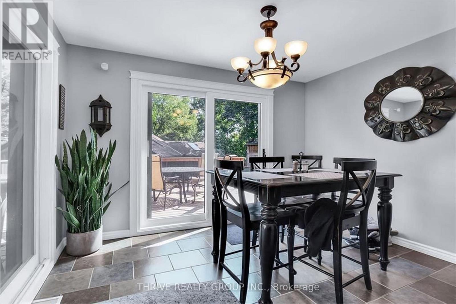 A dining room with a table set for four.