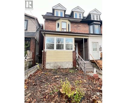 A house with a brown brick wall and a beige garage door.