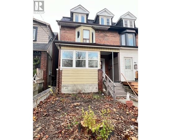 A house with a brown brick wall and a beige garage door.