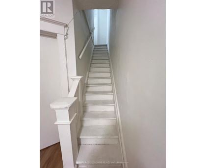 A long white staircase with a wooden floor.