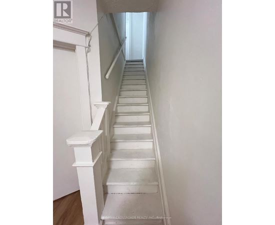 A long white staircase with a wooden floor.