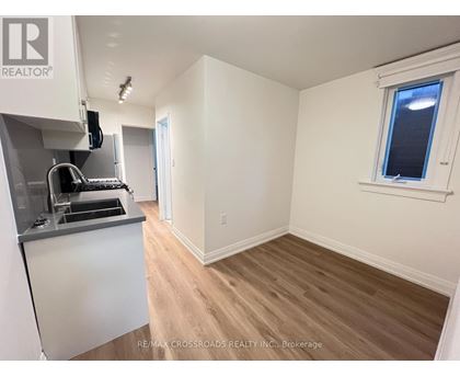 A kitchen area with a sink and a window.