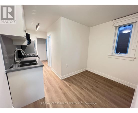 A kitchen area with a sink and a window.