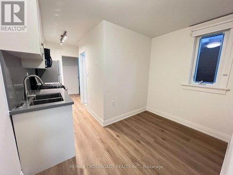 A kitchen area with a sink and a window.