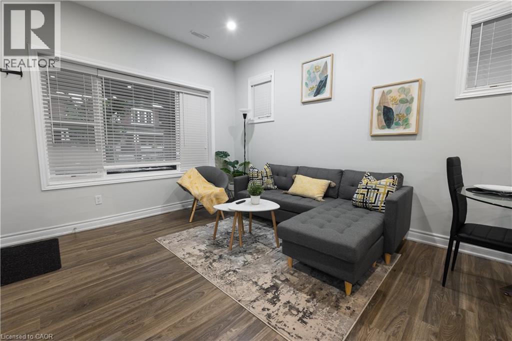 A living room with a grey couch, yellow pillows, and a wooden coffee table.