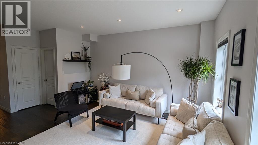 A living room with a black chair, a white couch, and a coffee table.