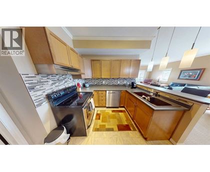 A kitchen with wooden cabinets and a black stove top oven.