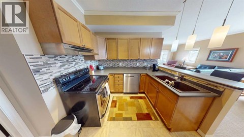 A kitchen with wooden cabinets and a black stove top oven.