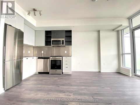 A spacious kitchen with stainless steel appliances and a large island.