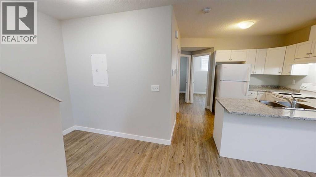 A kitchen area with a sink and a countertop.