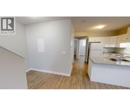 A kitchen area with a sink and a countertop.
