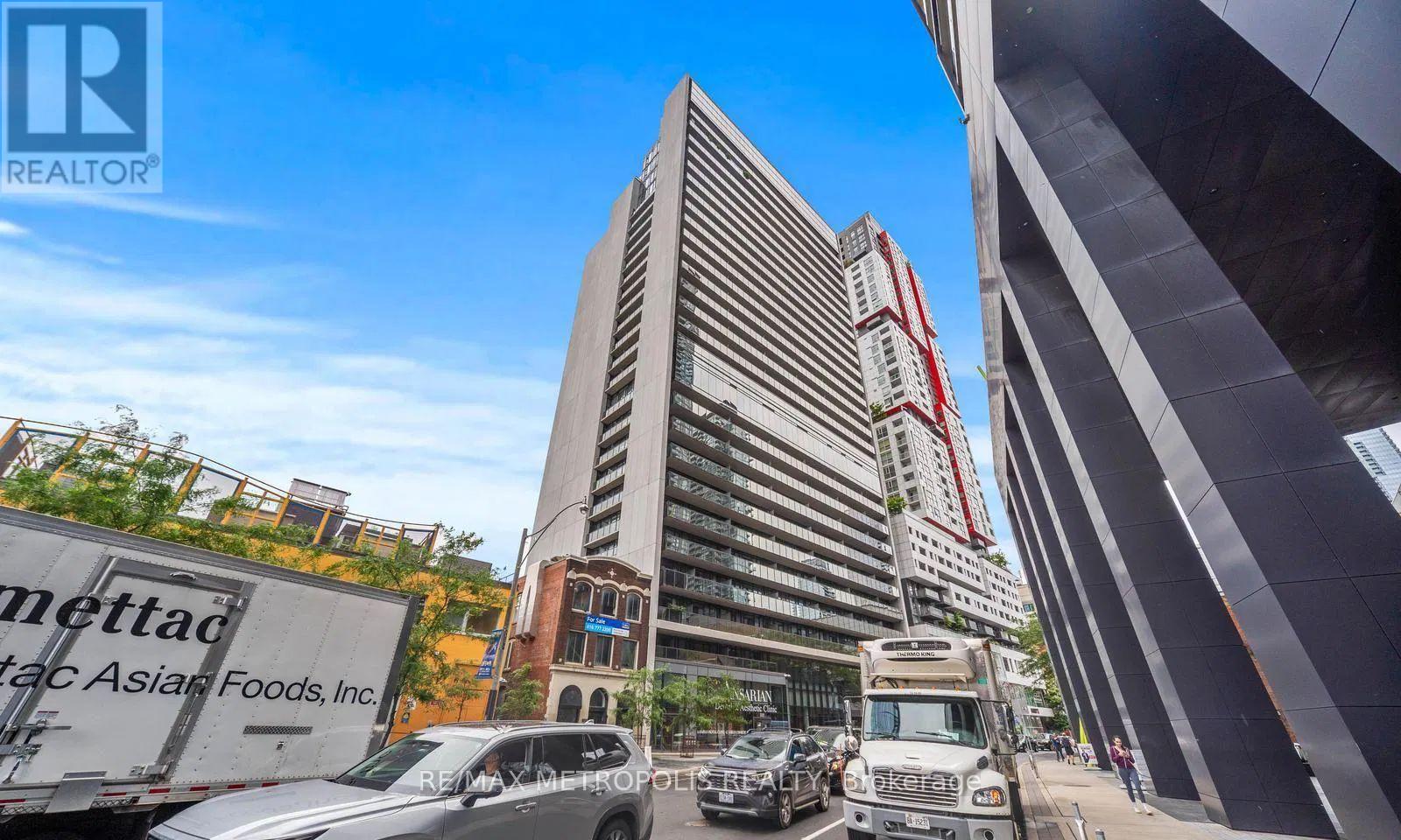 A tall building with a red and white striped awning in front of it.