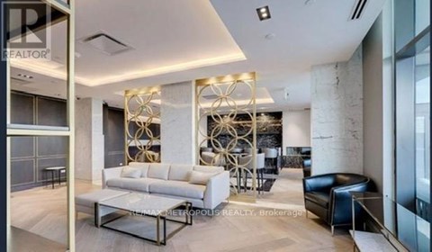 A modern living room with a white sofa and a glass table.