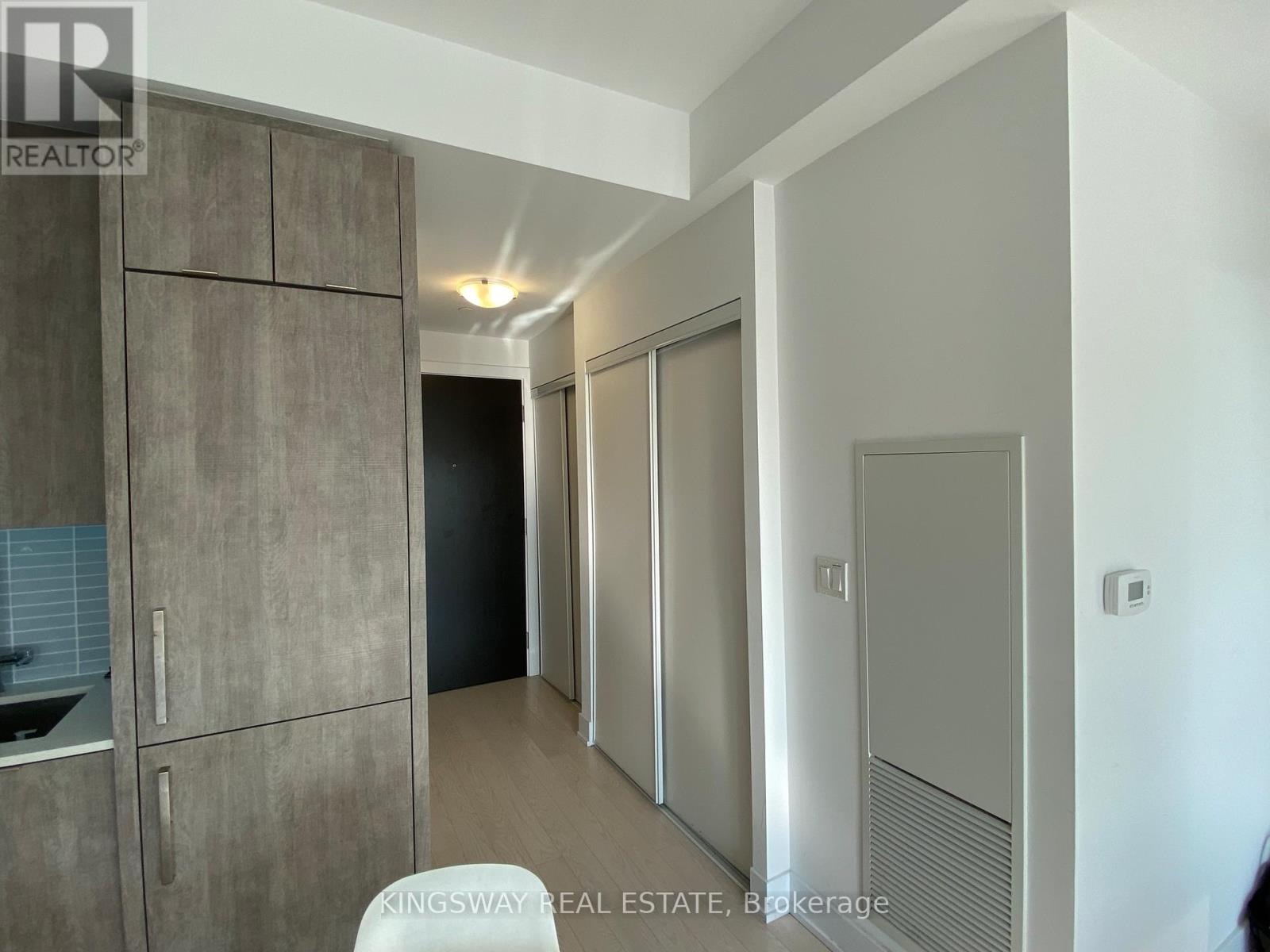A modern kitchen with a sink and a refrigerator.