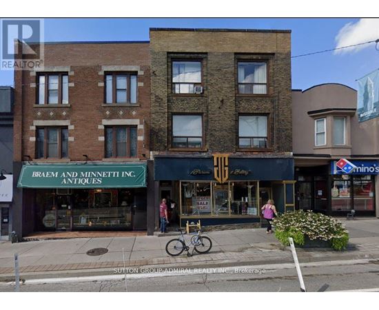 A street view of a building with a sign that says Braem and Minnett Inc. Antiques.