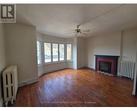 A room with a fireplace and a fan.