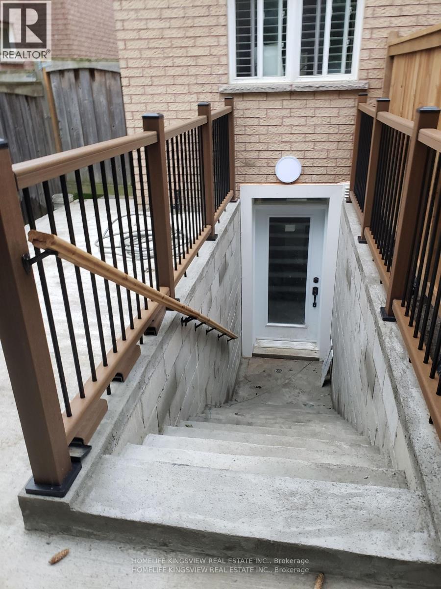 A staircase with a white door at the bottom.