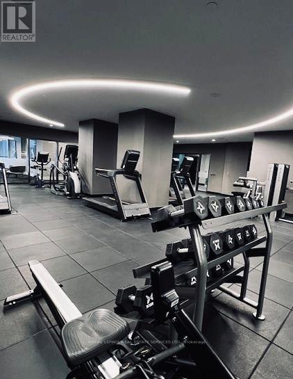 A gym with a variety of equipment including treadmills, weights, and exercise machines.