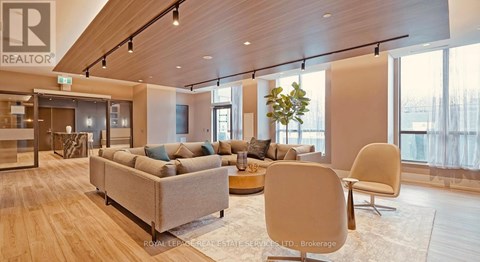 A living room with a couch, chairs and a coffee table.