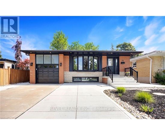 A modern house with a black garage door is for sale.