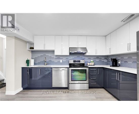 A modern kitchen with white cabinets and a grey backsplash.
